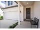 Inviting front porch with stylish bench, plants and charming door wreath, leading to a well-maintained home at 1639 Meadowlark Dr, Deltona, FL 32725