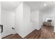 Bright hallway with wood-look floors leading to a desk and computer in an open upper level living space at 1639 Meadowlark Dr, Deltona, FL 32725