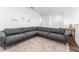 Bright living area with a large sectional couch, neutral rug, and stylish decor, creating a welcoming and cozy space at 1639 Meadowlark Dr, Deltona, FL 32725