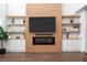 Stylish living room featuring a modern fireplace, display shelves, and hardwood floors at 1639 Meadowlark Dr, Deltona, FL 32725