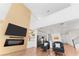 Open-concept living area with modern fireplace, kitchen access, and comfortable seating at 1639 Meadowlark Dr, Deltona, FL 32725