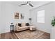 Inviting living room with neutral sofa, modern ceiling fan, and stylish decor at 1639 Meadowlark Dr, Deltona, FL 32725