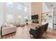 Stunning living room with tall windows, fireplace, and comfortable seating arrangements at 1639 Meadowlark Dr, Deltona, FL 32725
