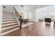 Open floor plan showcasing stairs, dining area, and a cozy living room with large windows at 1639 Meadowlark Dr, Deltona, FL 32725