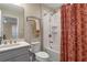 Bathroom features a shower-tub combo and vanity with a white countertop at 16781 Wingspread Loop, Winter Garden, FL 34787