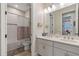 Bathroom features a double sink vanity, a tub-shower combo, and modern finishes at 16781 Wingspread Loop, Winter Garden, FL 34787