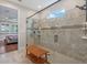 Stunning primary bathroom featuring a large glass shower with a bench at 16781 Wingspread Loop, Winter Garden, FL 34787
