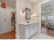 Bathroom featuring modern vanity, walk in closet, and access to main bedroom at 16781 Wingspread Loop, Winter Garden, FL 34787