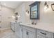 Bright bathroom features double sink vanity with white countertop at 16781 Wingspread Loop, Winter Garden, FL 34787