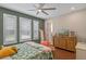 Bright bedroom with green accent wall and beautiful wood floors at 16781 Wingspread Loop, Winter Garden, FL 34787