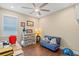 Bright bedroom with hardwood floors, a ceiling fan, and a window at 16781 Wingspread Loop, Winter Garden, FL 34787
