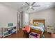 Spacious bedroom featuring a ceiling fan, plush bed and wooden floors at 16781 Wingspread Loop, Winter Garden, FL 34787