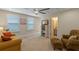 Bright bonus room features neutral decor, a ceiling fan, and comfortable seating at 16781 Wingspread Loop, Winter Garden, FL 34787