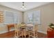 Cozy breakfast nook featuring bright natural light and a charming chandelier with seating for four at 16781 Wingspread Loop, Winter Garden, FL 34787