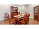 Elegant dining room featuring a wooden table with seating for six, hardwood floors and a china cabinet at 16781 Wingspread Loop, Winter Garden, FL 34787