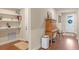Inviting entryway featuring wood floors, built-in shelves, and a charming wooden cabinet at 16781 Wingspread Loop, Winter Garden, FL 34787