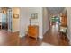 Hallway with beautiful wood floors, leading to various rooms of the house at 16781 Wingspread Loop, Winter Garden, FL 34787