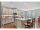 Charming kitchen features stainless appliances, granite counters, and a cozy breakfast nook at 16781 Wingspread Loop, Winter Garden, FL 34787