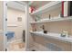Well-organized laundry room with floating shelves at 16781 Wingspread Loop, Winter Garden, FL 34787