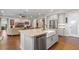 Spacious living area with an open kitchen featuring stainless appliances and sleek countertops at 16781 Wingspread Loop, Winter Garden, FL 34787