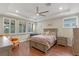 Elegant main bedroom with hardwood floors, natural light, and tray ceilings at 16781 Wingspread Loop, Winter Garden, FL 34787