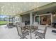 Covered outdoor patio with dining and lounge area with a scenic view at 16781 Wingspread Loop, Winter Garden, FL 34787