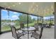 Screened-in patio with a waterfront view and comfortable seating at 16781 Wingspread Loop, Winter Garden, FL 34787