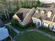 Aerial view of townhome with dormer windows, well-manicured lawn, and blue shutters at 1920 Island Walk Dr, Orlando, FL 32824