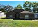 Charming single-story home featuring a well-maintained lawn and complemented by mature trees at 1931 Clarcona Rd, Apopka, FL 32703