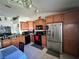 Functional kitchen with stainless steel appliances, ample cabinetry, and tile flooring, perfect for cooking at 1931 Clarcona Rd, Apopka, FL 32703