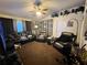 Inviting living room with leather furniture, ceiling fan, and unique wall decor at 1931 Clarcona Rd, Apopka, FL 32703