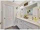 Bathroom boasts double sinks, a large mirror, bright lighting, and white cabinetry for a clean and modern feel at 2136 Topping Pl, Eustis, FL 32726