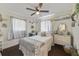 Cozy bedroom with hardwood floors, a ceiling fan, and plenty of natural light from the windows at 2136 Topping Pl, Eustis, FL 32726