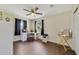 This bedroom features dark curtains, vinyl floors, a ceiling fan, and a vanity with hollywood style lights at 2136 Topping Pl, Eustis, FL 32726