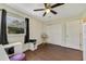 Bright bedroom with a ceiling fan, dark curtains, a large closet, vinyl floors, and natural light at 2136 Topping Pl, Eustis, FL 32726