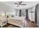 Relaxing bedroom featuring vinyl floors, a ceiling fan, light grey paint, and light-colored neutral furniture at 2136 Topping Pl, Eustis, FL 32726