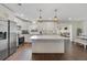 Modern kitchen boasts stainless steel appliances, quartz countertops, and an open layout at 2136 Topping Pl, Eustis, FL 32726