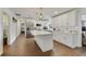 Contemporary kitchen with white cabinetry, an island, and hardwood flooring at 2136 Topping Pl, Eustis, FL 32726