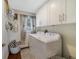 Functional laundry room equipped with modern washer and dryer units and ample cabinet space at 2136 Topping Pl, Eustis, FL 32726