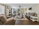 Comfortable living room featuring vinyl floors, neutral furniture, lots of windows, and direct access to the patio at 2136 Topping Pl, Eustis, FL 32726