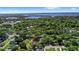 Long shot shows a stunning home with a lake view in a lushly landscaped neighborhood at 2140 Lilypad Ln, Windermere, FL 34786