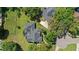 Overhead shot shows maintained lawns, a screened in pool, and several mature trees at 2140 Lilypad Ln, Windermere, FL 34786