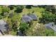 Expansive aerial view showcases a well-maintained home, screened pool, mature trees and lush landscaping at 2140 Lilypad Ln, Windermere, FL 34786