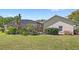 A lush backyard featuring a screened lanai, providing a private retreat surrounded by natural beauty at 2140 Lilypad Ln, Windermere, FL 34786