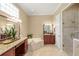 Bright bathroom featuring a soaking tub, granite counters, vanity and glass enclosed shower at 2140 Lilypad Ln, Windermere, FL 34786