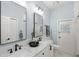 This bathroom features double sinks, white cabinets, granite counters, modern lighting and a door to the yard at 2140 Lilypad Ln, Windermere, FL 34786