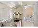 This bathroom showcases granite countertops, double sinks, a large mirror, and a view into the Primary bedroom at 2140 Lilypad Ln, Windermere, FL 34786