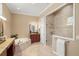 Bright bathroom featuring a soaking tub, granite counters, vanity and glass enclosed shower at 2140 Lilypad Ln, Windermere, FL 34786