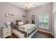 A warmly decorated bedroom featuring wood floors, a window and a comfortable bed at 2140 Lilypad Ln, Windermere, FL 34786