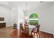 Bright dining room features wood floors, a modern chandelier, and a view of the landscaped yard at 2140 Lilypad Ln, Windermere, FL 34786